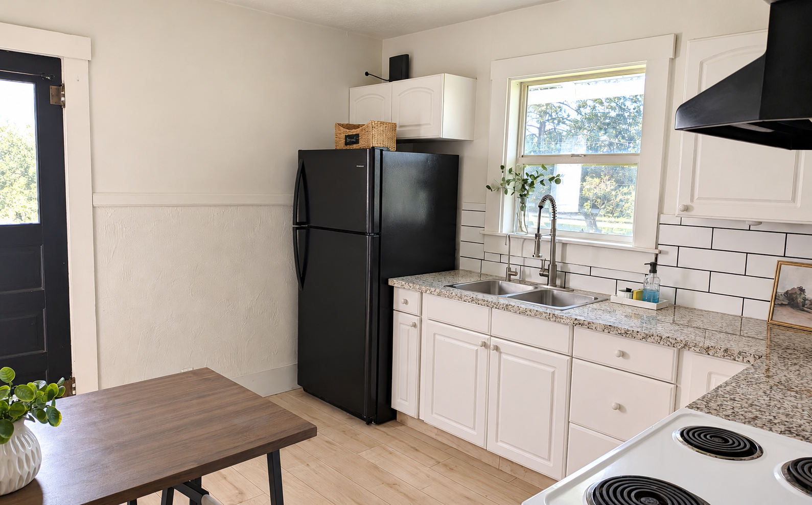 A bright rental kitchen with natural wood details